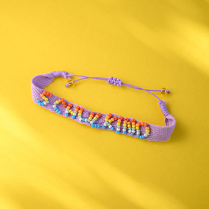 Ava&Yves - Gewebtes Armband mit handbestickten Perlen Schulkind, flieder mit Säckchen blau/weiss
